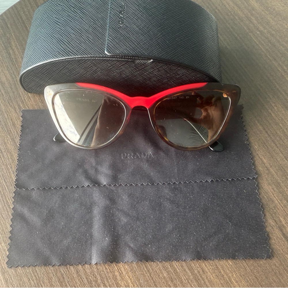 Prada women’s black fox sunglasses.